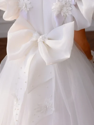 Luxury girl's dress with a big bow, flowers and beads