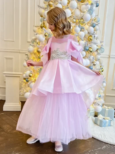 Stylish ball gown for a girl with wide tiered skirt and big bows